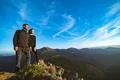 The smiling couple standing on the beautiful mountain landscape background Photo