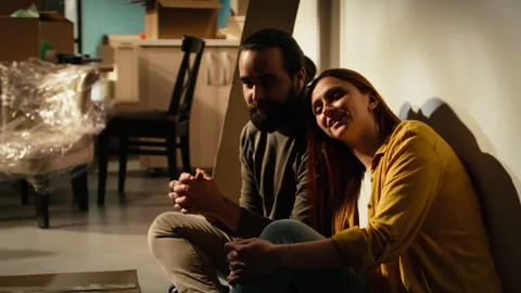 Smiling couple takes break from unpacking furniture and personal belongings Stock Footage 342904355