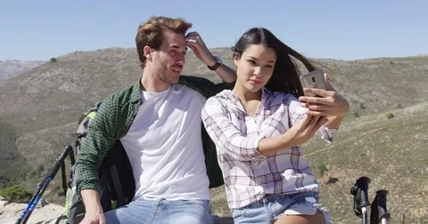 Smiling couple taking selfie in mountains Stock Footage