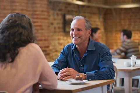 Smiling couple talking in cafe Stock Photos