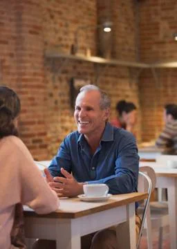 Smiling couple talking in cafe Stock Photos