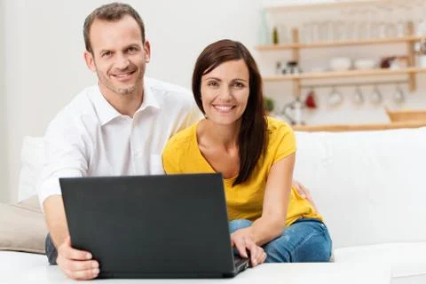Smiling couple using a laptop computer Foto stock
