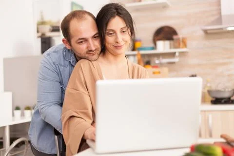 Smiling couple using laptop Stock Photos
