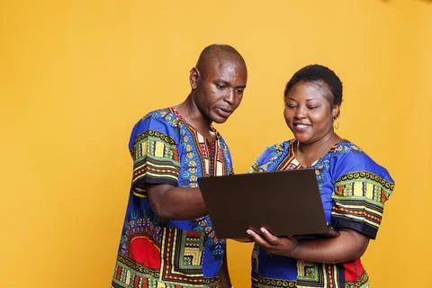 Smiling couple using laptop together Stock Photos
