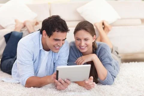 Smiling couple using a tablet computer Stock Photos
