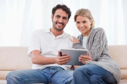 Smiling couple using a tablet computer Stock Photos