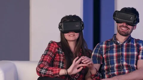 Smiling couple in virtual reality headset watching movie Video stock 74389875