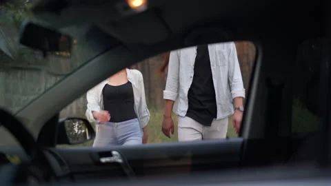 Smiling couple walking in forest to car opening door sitting on passenger seat Stock Footage 204810401