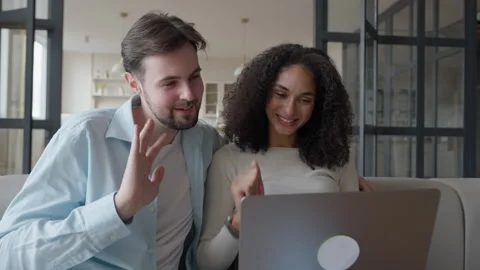 Smiling Couple Waves Goodbye During Video Call, Enjoying Online Conversation Stock Footage 303085965