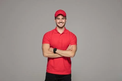 Smiling courier man posing in studio. 스톡 사진