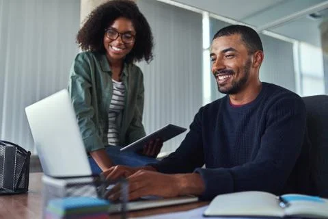 Smiling creative colleagues working together in the office Stock Photos