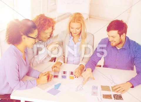 Smiling creative team looking at sketch Stock Photos