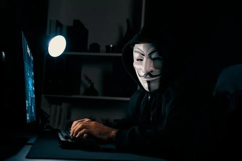 Smiling criminal anonymous mask looking camera, effective encryption. Surmise. 写真素材