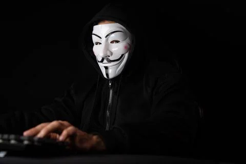 Smiling criminal anonymous mask looking camera, effective encryption. Surmise. 写真素材