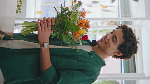 Smiling customer purchase flower composition in bouquet shop vertically oriented Stock Footage 254594998