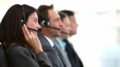 Smiling customer service agents working in a call center Видео 1017975