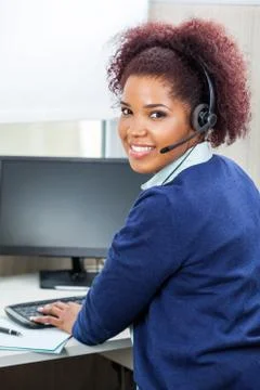 Smiling Customer Service Representative Using Computer 写真素材