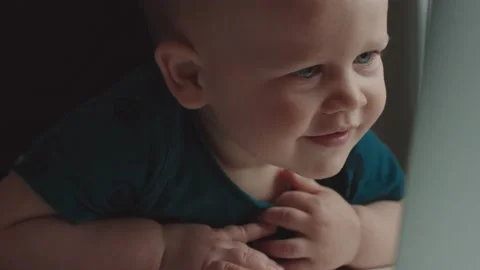 Smiling Cute Babe watching interesting cartoons on a laptop. Closeup Stock Footage 147032059