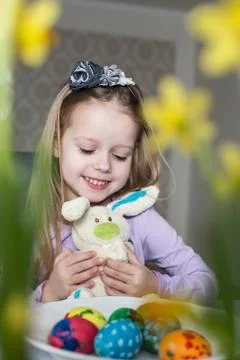 Smiling cute child with easter eggs and plush bunny. Easter, holiday Stock Photos