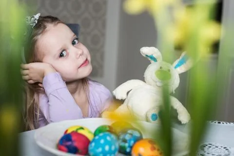Smiling cute child with easter eggs and plush bunny. Easter, holiday Stock Photos