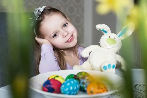 Smiling cute child with easter eggs and plush bunny. Easter, holiday Stock Photos