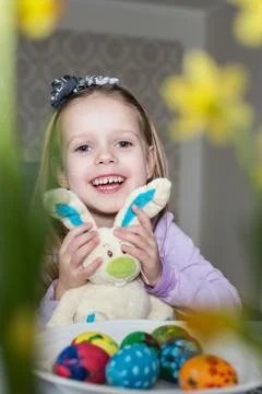 Smiling cute child with easter eggs and plush bunny. Easter, holiday Stock-Fotos