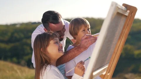 Smiling dad and children draw a picture Stock Footage 80840584