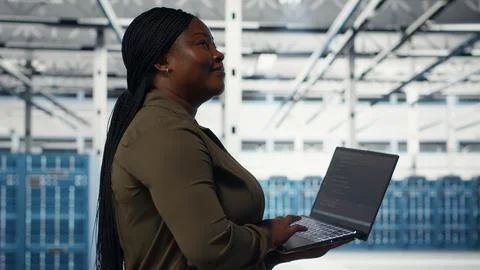 Smiling data center engineer pleased after minimizing downtime Stock Photos