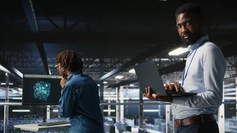 Smiling data center engineering team on industrial platform Stock Photos