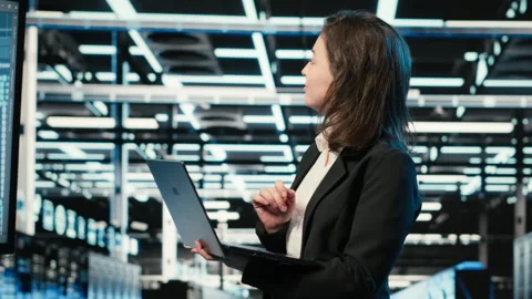 Smiling data center female engineer pleased after upgrading AI systems Stock Footage 329324090