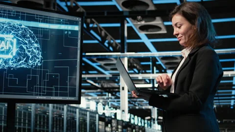 Smiling data center female engineer pleased after upgrading AI systems Stock Footage 329329578
