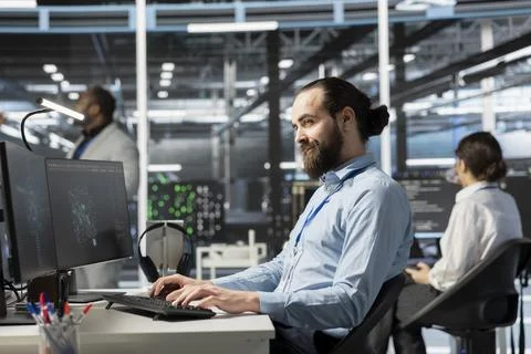 Smiling data center IT professional using artificial intelligence Stock Photos