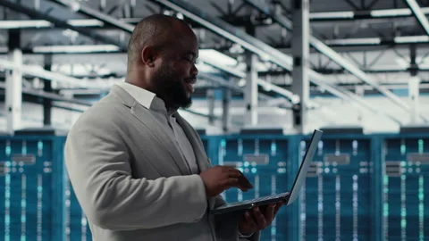 Smiling data center programmer using laptop to upgrade system stability Stock-Footage 311961907