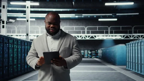 Smiling data center technician installing server racks systems using tablet Stock Footage 311898075