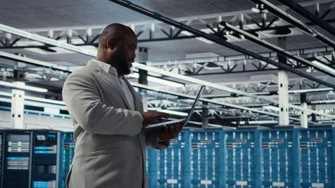 Smiling data center technician installing and upgrading hardware components 스톡 사진