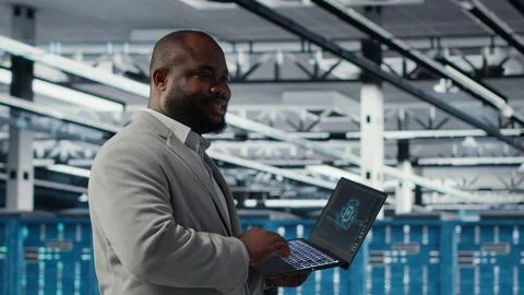 Smiling data center technician installing and upgrading hardware components 스톡 사진