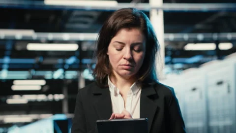 Smiling data center technician optimizing server load balancing using tablet app Stock Footage 328334491