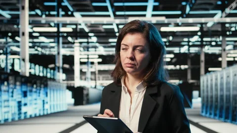 Smiling data center technician optimizing server load balancing using tablet app Stock Footage 329329973