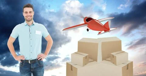 Smiling delivery man with boxes and plane flying in background Stock Photos