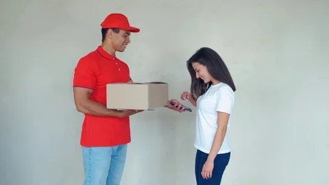 Smiling delivery man delivering parcel to a woman Stock Footage 112759751
