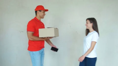 Smiling delivery man delivering parcel to a woman Stock Footage 112759857