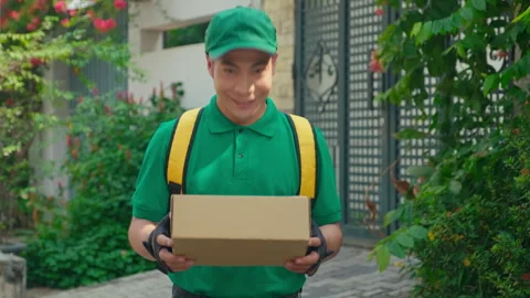 Smiling Delivery Man with Parcel for Customer Stockbeeldmateriaal 244633627