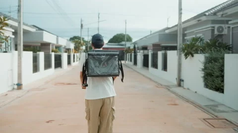 Smiling delivery man with thermal backpack riding on an electric scooter, del Stock Footage 202204469