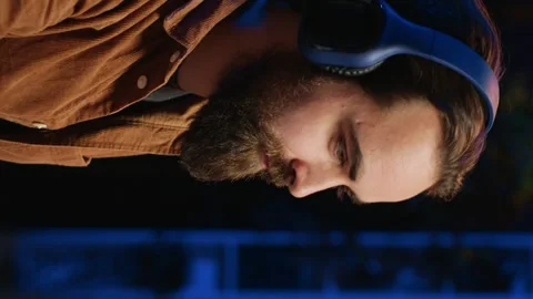 Smiling developer listening music while doing programming, close up Stock Footage 265108394