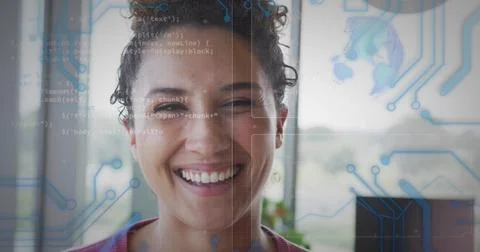 Smiling developer in red top standing before office window, code and circuit Stock Photos