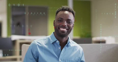 Smiling developer sitting in office cubicle, initiating drifting red glyphs, Video stock 328007370