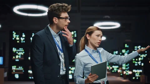 Smiling developers couple talking night datacenter closeup. Colleagues working Stock Footage 260260230