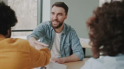 Smiling diverse HR managers satisfied about male job employee, have positive Stock Footage 234063368