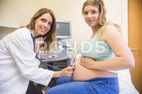 Smiling Doctor Checking A Pregnant Woman