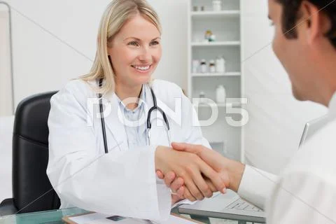 Smiling Doctor Greeting Her Patient